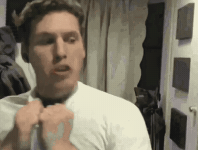 Man In White Shirt Adjusting Shirt In Mirror GIF