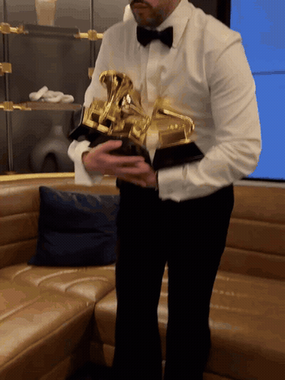 Man In White Shirt And Black Bow Tie Holding Trophy GIF