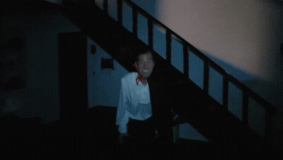Man In White Shirt And Black Cape Walking Down Stairs GIF