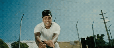 Man In White Shirt And Black Hat By Chain Link Fence GIF