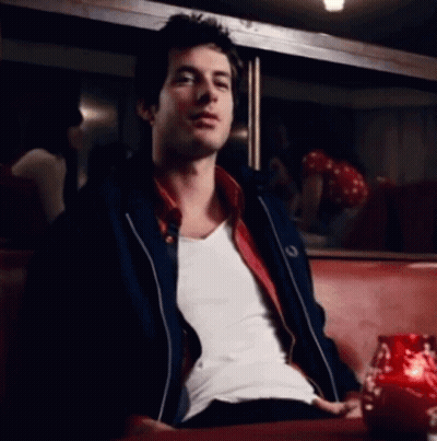 Man In White Shirt And Black Jacket On Red Couch GIF