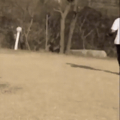 Man In White Shirt And Black Pants Running On Dirt Field GIF