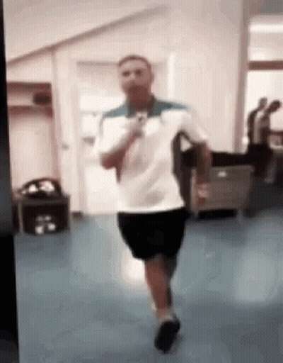 Man In White Shirt And Black Shorts Running GIF