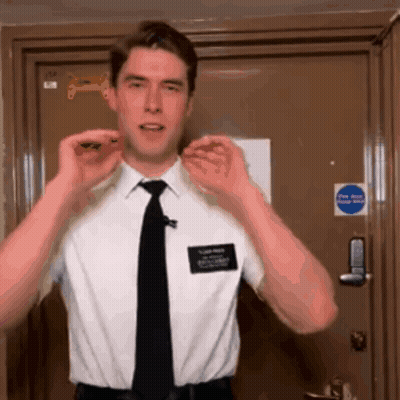 Man In White Shirt And Black Tie By Fire Exit Door GIF