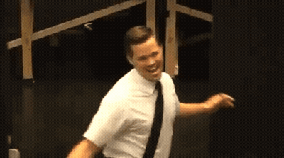 Man In White Shirt And Black Tie In Dark Room GIF