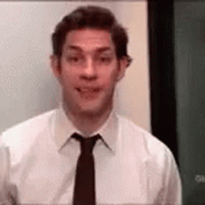 Man In White Shirt And Black Tie In Front Of Green Board GIF