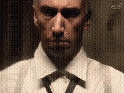 Man In White Shirt And Black Tie Looking At Camera GIF