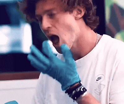 Man In White Shirt And Blue Gloves Eating GIF