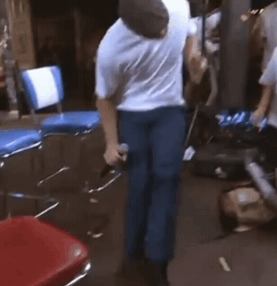 Man In White Shirt And Blue Jeans Dancing With Microphone GIF