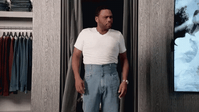 Man In White Shirt And Blue Jeans In Closet GIF