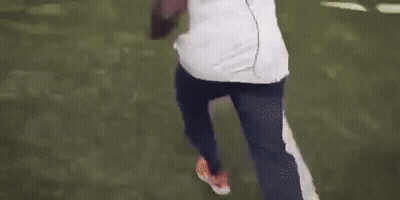Man In White Shirt And Blue Pants Walking On Football Field GIF