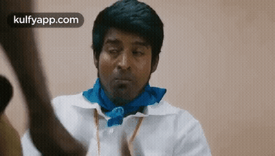 Man in White Shirt and Blue Scarf Looking