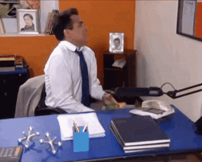 Man In White Shirt And Blue Tie At Desk With Calculator GIF