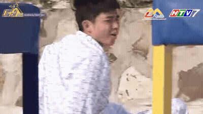 Man In White Shirt And Blue Yellow Fence GIF