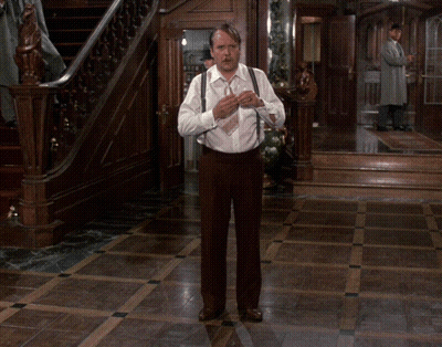 Man In White Shirt And Brown Pants Standing In Room GIF