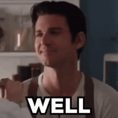 Man In White Shirt And Brown Suspenders Saying Well GIF