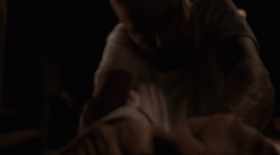 Man In White Shirt And Glasses On Table In Dark GIF