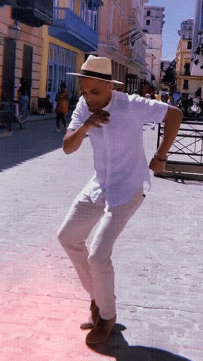 Man In White Shirt And Hat Dancing On Street GIF