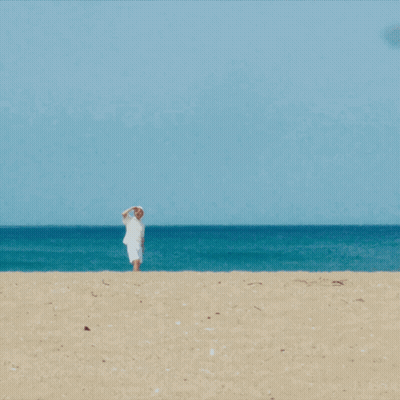Man In White Shirt And Hat On Beach GIF
