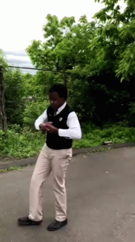 Man In White Shirt And Khaki Pants On Road GIF