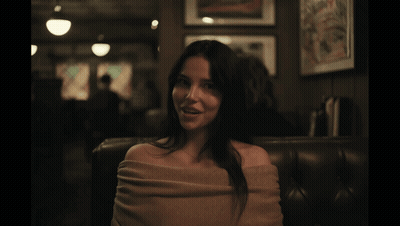 Man In White Shirt And Red Beads Holding Phone GIF