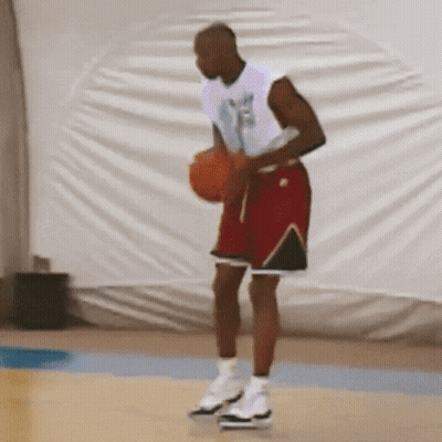 Man In White Shirt And Red Shorts Holding Basketball GIF