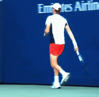 Man In White Shirt And Red Shorts Running On Tennis Court GIF