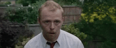 Man In White Shirt And Red Tie At Brick Wall GIF