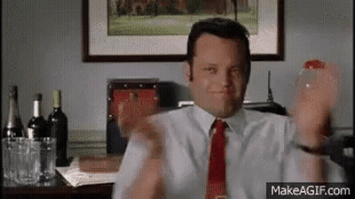 Man In White Shirt And Red Tie At Desk With Wine GIF