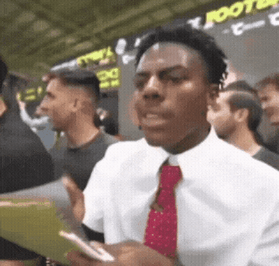 Man In White Shirt And Red Tie In Crowd GIF
