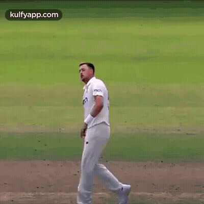 Man In White Shirt And Shorts Standing On Field With Hand In Air GIF