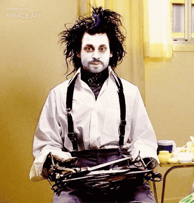 Man In White Shirt And Suspenders Holding Scissors GIF