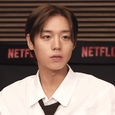 Man In White Shirt And Tie At Netflix Sign GIF