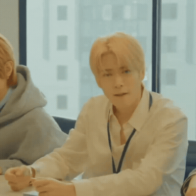 Man In White Shirt And Tie At Table With Window GIF