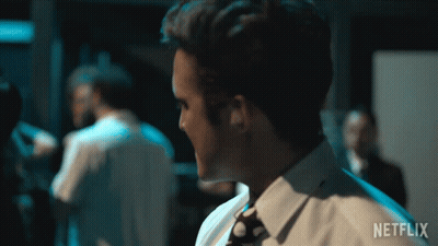 Man In White Shirt And Tie Before Netflix Sign GIF