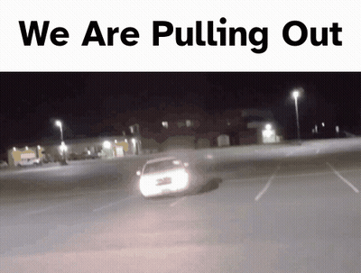 Man In White Shirt And Tie Dancing In Front Of NBC Sign GIF