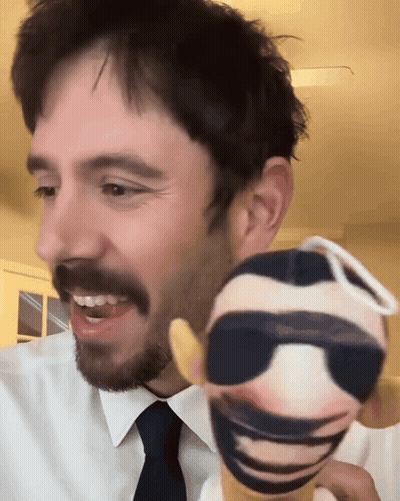 Man In White Shirt And Tie Holding Sunglasses Doll GIF