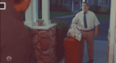 Man In White Shirt And Tie In Front Of NBC Mailbox GIF