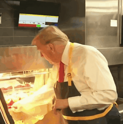 Man In White Shirt And Tie Looking At Food Display GIF