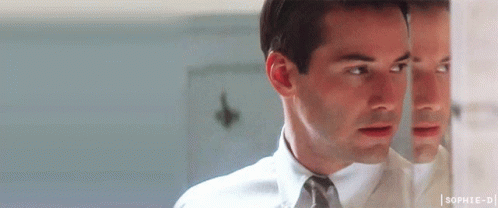 Man In White Shirt And Tie Looking At Reflection In Mirror GIF