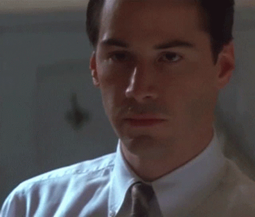 Man In White Shirt And Tie Looks At Something GIF