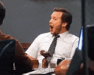 Man In White Shirt And Tie Sits At Desk GIF