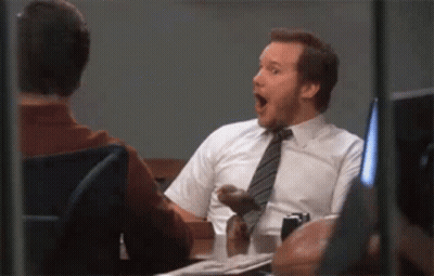Man In White Shirt And Tie Sitting At Table With Another Man GIF