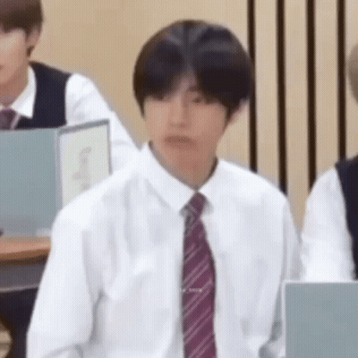 Man In White Shirt And Tie Sitting In Classroom GIF