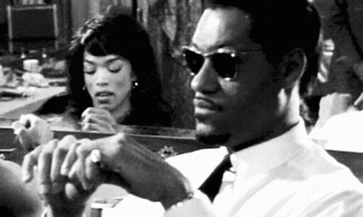 Man In White Shirt And Tie Sitting In Front Of Mirror While Woman Looks At Him GIF