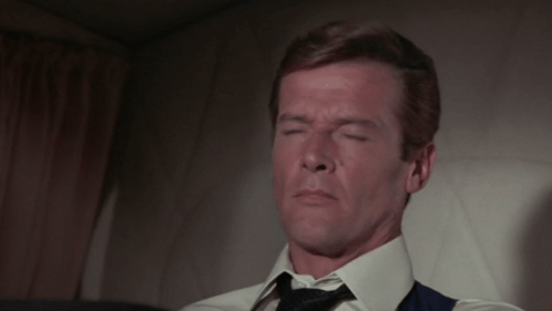 Man In White Shirt And Tie Sitting On Chair GIF