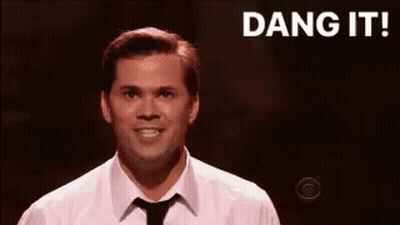 Man In White Shirt And Tie Smiling On Stage GIF
