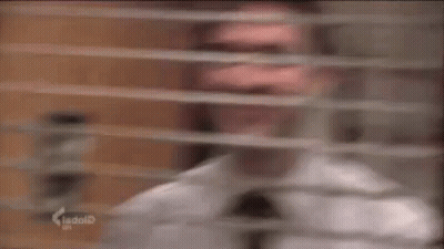 Man in White Shirt and Tie Smiling Out Window