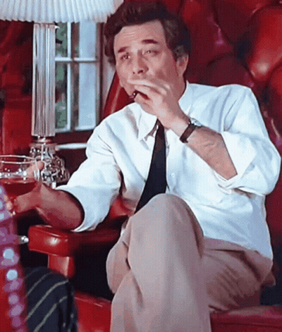 Man In White Shirt And Tie Smoking In Red Chair GIF