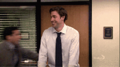 Man In White Shirt And Tie Standing By Window GIF